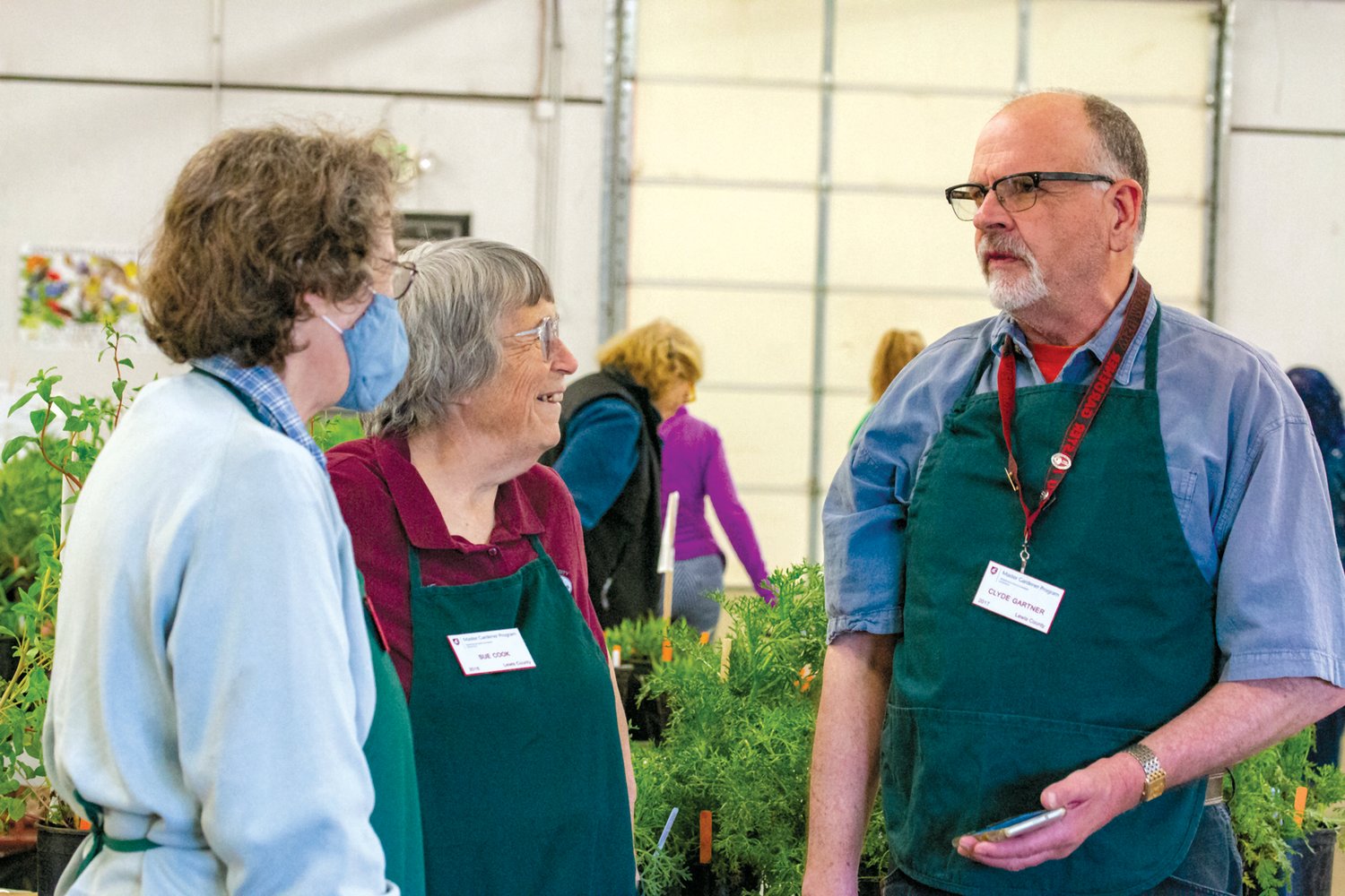 Master Gardener program members talk at the Master Garden Plant Sale at the Southwest Washington Fairgrounds on Saturday.